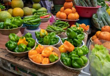 Green and orange peppers on display at a market in Mexico