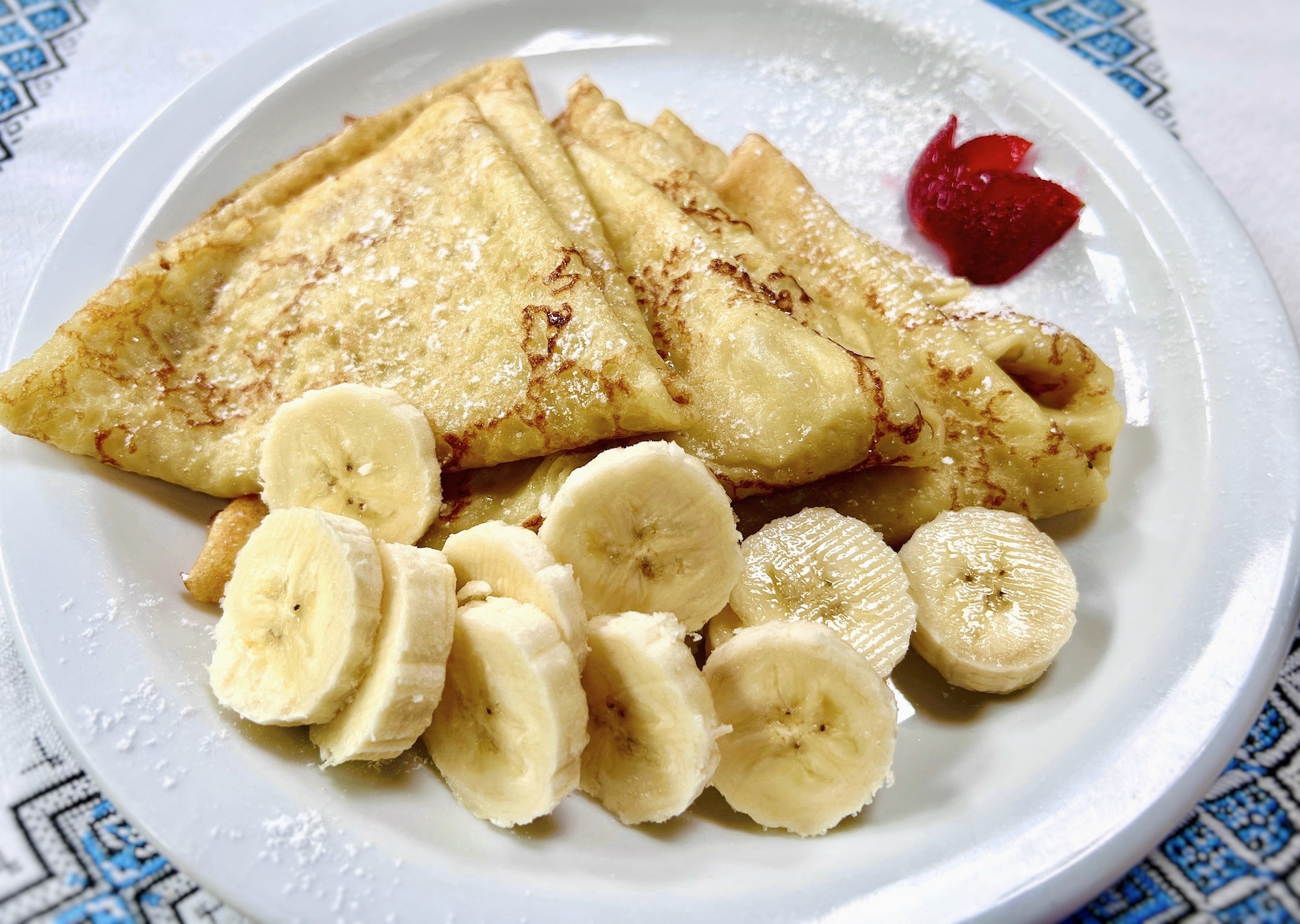 Ukrainian pancakes with banana and strawberries. Blini