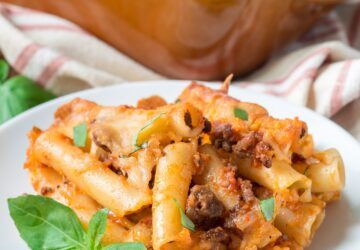 Ziti bolognese on a white plate, square format