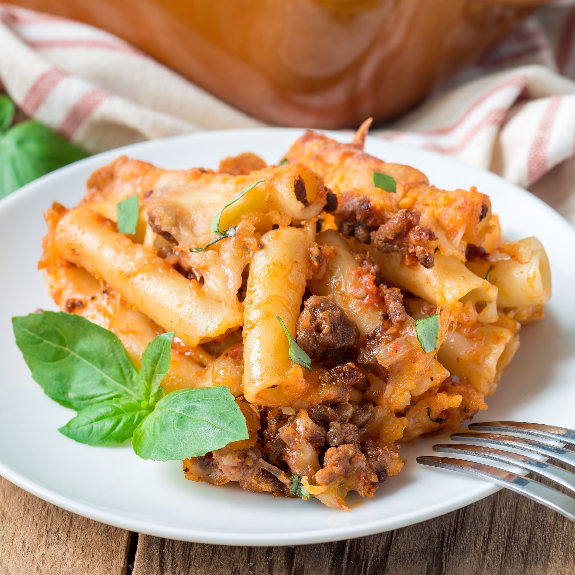 Ziti bolognese on a white plate, square format