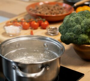 Metallic pan with boiling water and spaghetti