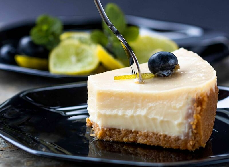 sliced cake on black plate