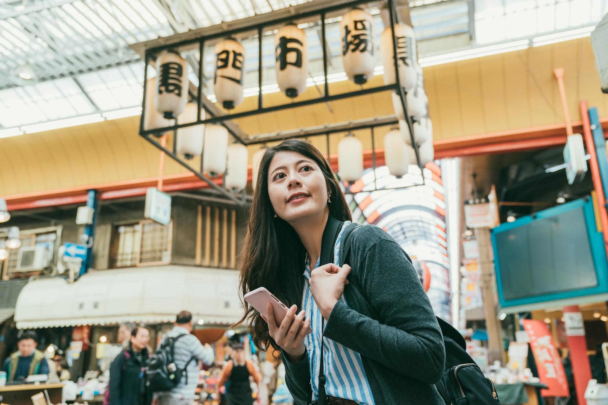 woman enjoying the vibe in kuromon ichiba market